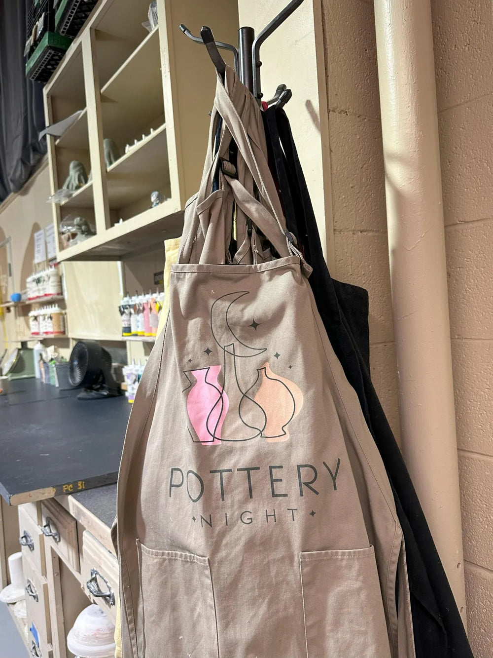 Pottery Night branded apron hanging