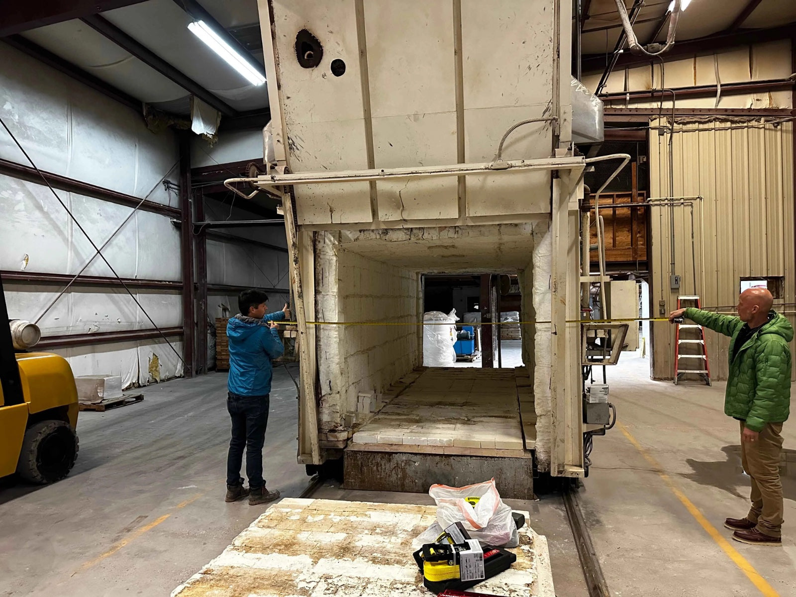 Inside the Diversified Ceramics facility, with Adam and Jeremy assessing the kiln